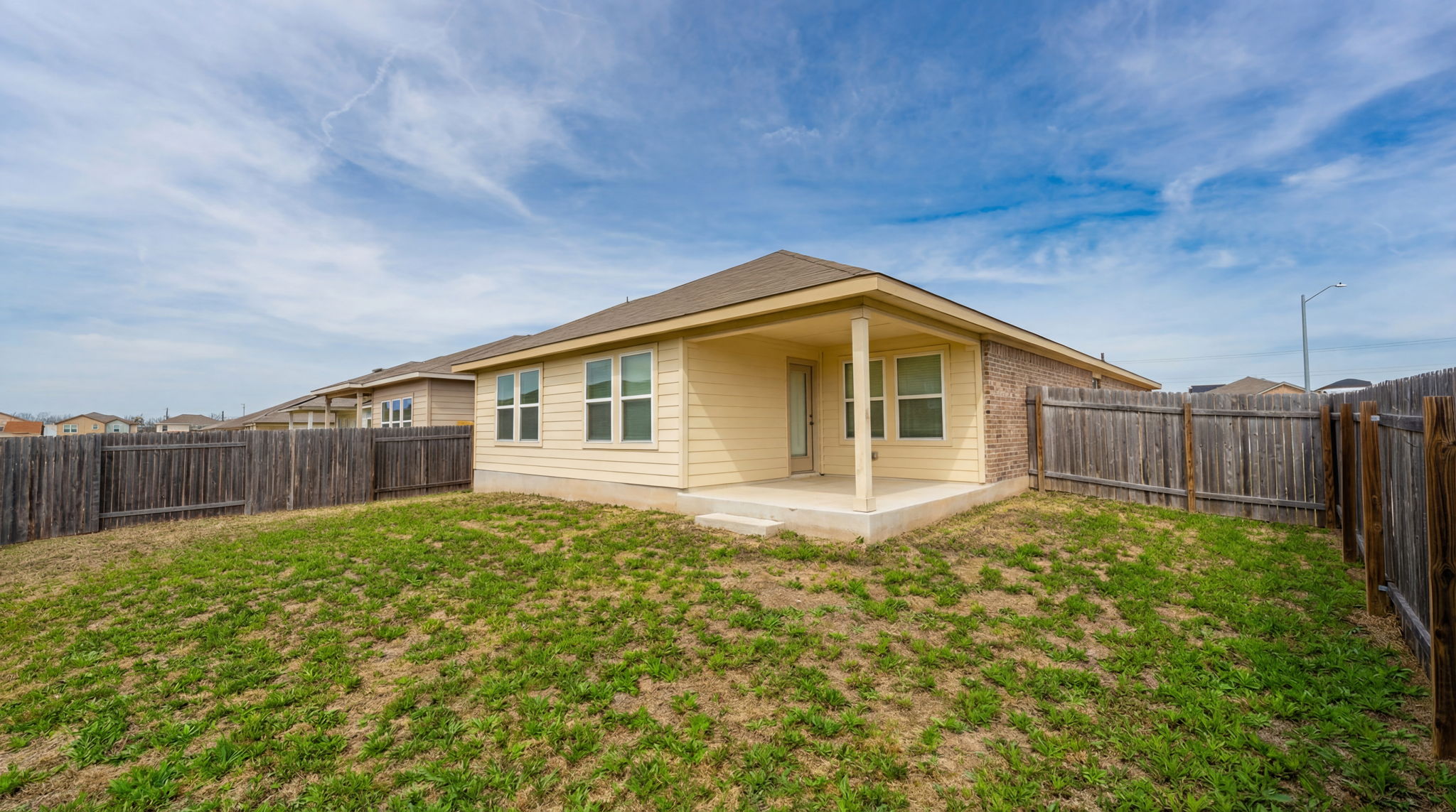 1003 Round Bale Road Hutto, TX 78634 - Photo 13 of 29 Rear view of property with a patio area and a fenced backyard