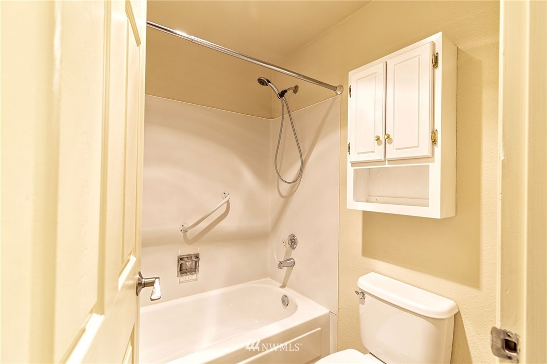 19410 Bothell Way Northeast, Unit D201 Bothell, WA 98011 - Photo 12 of 22 a bathroom with a bathtub and a toilet