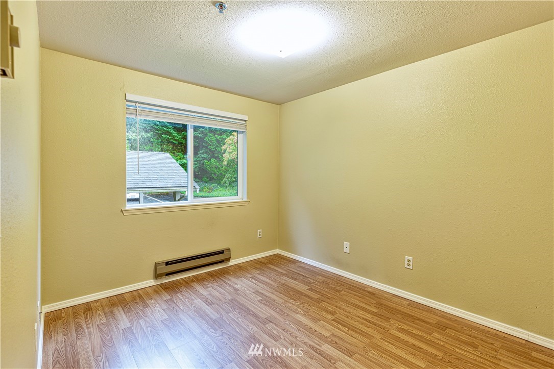 19410 Bothell Way Northeast, Unit D201 Bothell, WA 98011 - Photo 14 of 22 an empty room with wooden floor and windows