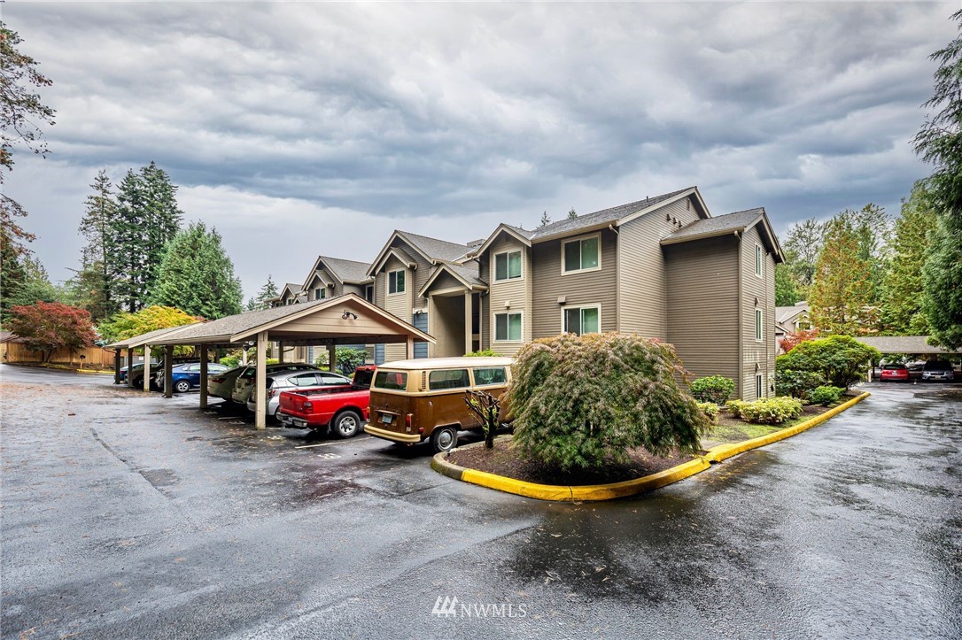 19410 Bothell Way Northeast, Unit D201 Bothell, WA 98011 - Photo 22 of 22 a car parked in front of a house