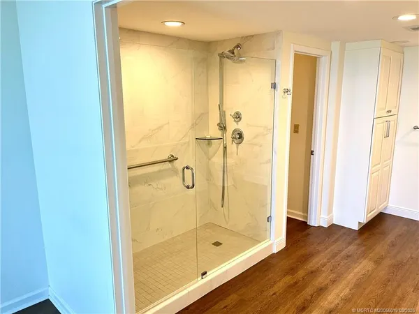 a bathroom with a glass shower door