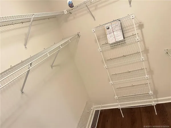 a view of walk in closet with empty racks