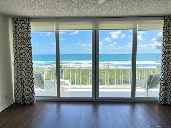 a view of room with window and wooden floor
