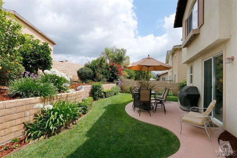 1636 Marigold Lane Simi Valley, CA 93065 - Photo 18 of 21 a view of a patio with a table and chairs under an umbrella