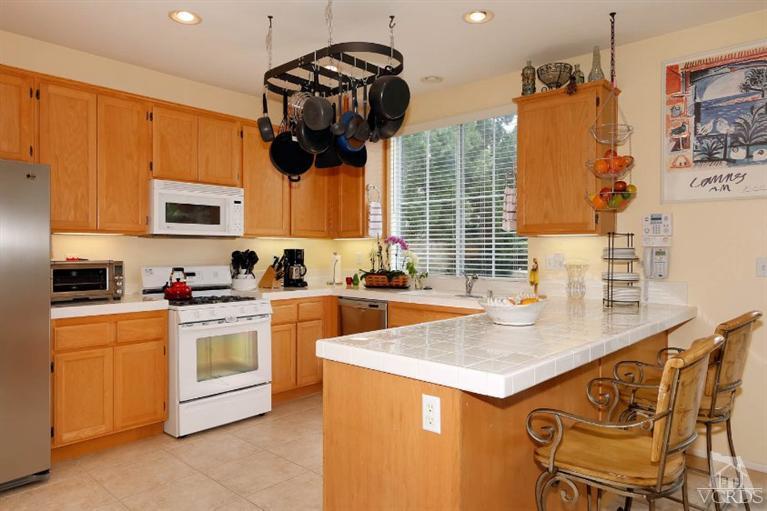 1636 Marigold Lane Simi Valley, CA 93065 - Photo 5 of 21 a kitchen with stainless steel appliances granite countertop a sink a stove and a microwave