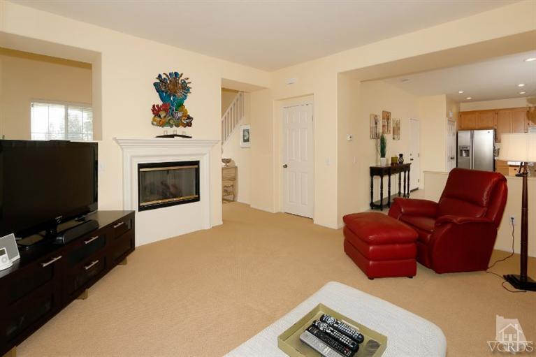 1636 Marigold Lane Simi Valley, CA 93065 - Photo 9 of 21 a living room with furniture a flat screen tv and a fireplace