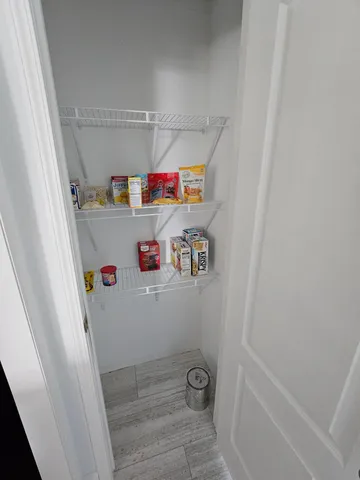 a kitchen with sink a microwave and cabinets