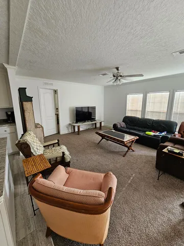 a living room with a couch and a wooden floor