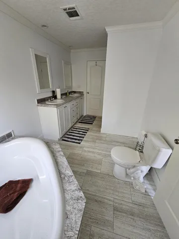 a spacious bathroom with a sink and a toilet