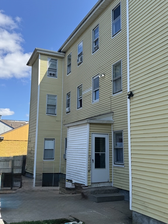24-28 Hall Street Fall River, MA 02724 - Photo 5 of 18 a front view of a house with a yard