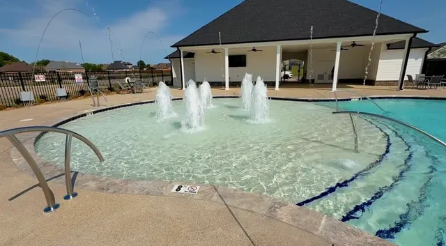 a view of a swimming pool with a patio