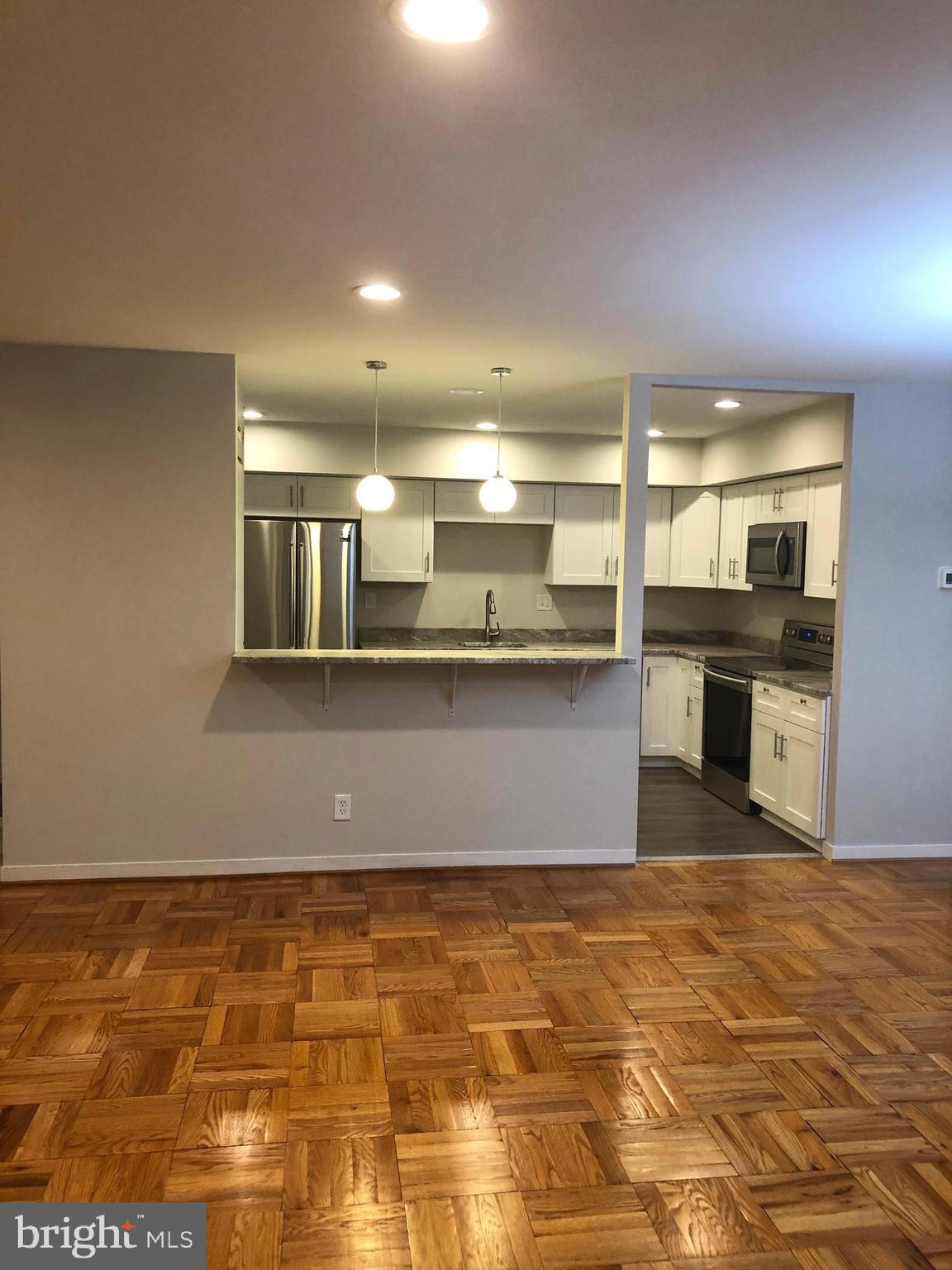 14 Stonehenge Circle, Unit 6 Baltimore, MD 21208 - Photo 9 of 31 LIVING ROOM INTO KITCHEN