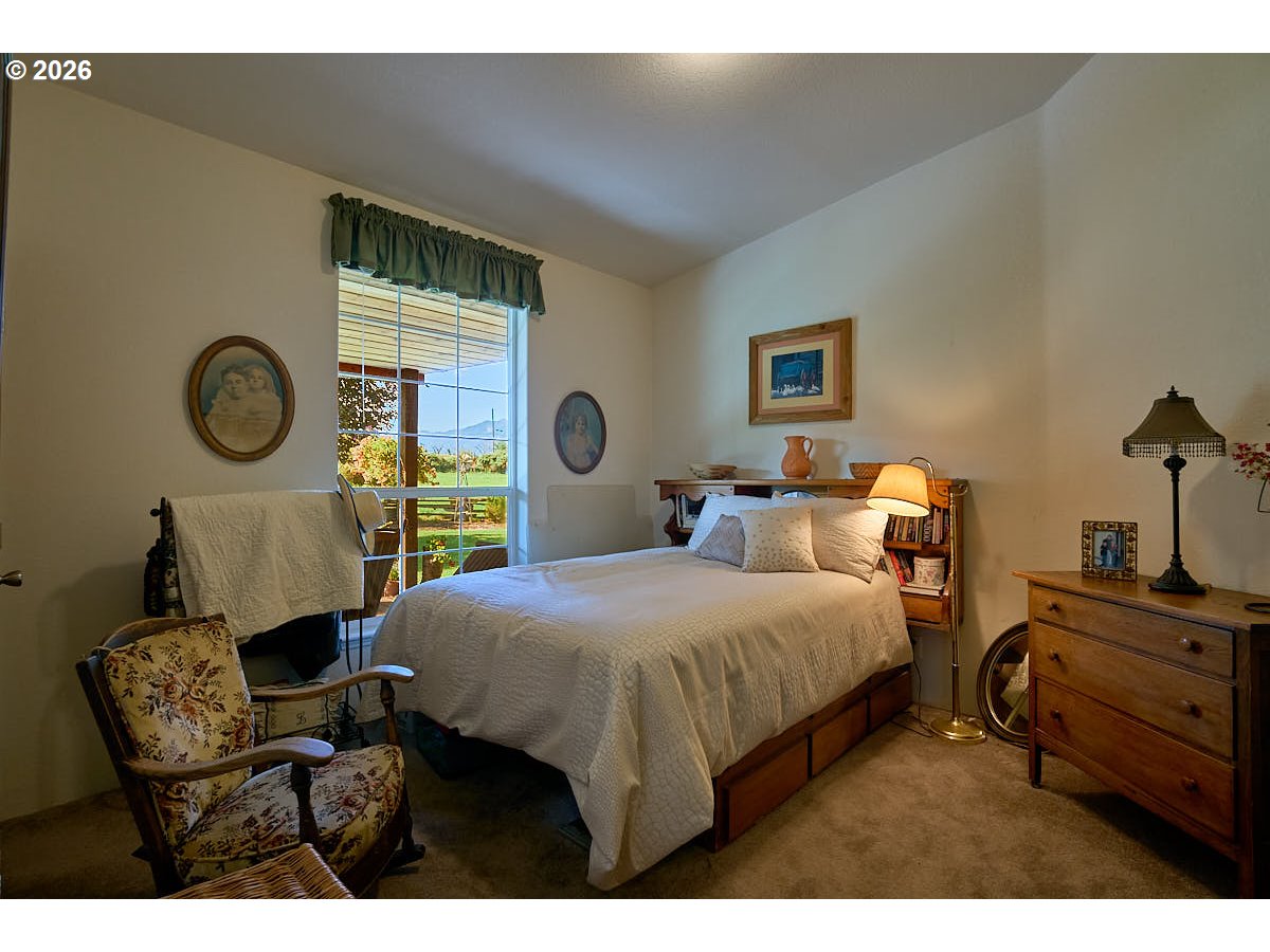 67079 Lostine River Road Lostine, OR 97857 - Photo 22 of 41 a bedroom with a bed a dresser and chair