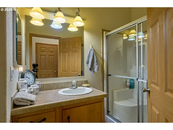 a bathroom with a sink vanity granite and a mirror