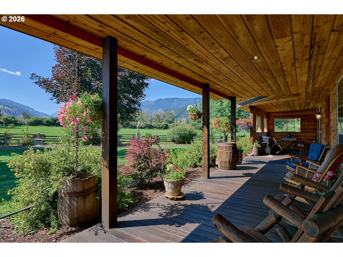 67079 Lostine River Road Lostine, OR 97857 - Photo 25 of 41 a view of a patio with table and chairs potted plants with wooden floor and floor to ceiling window
