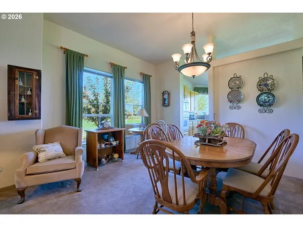 a dining room with furniture a livingroom and chandelier