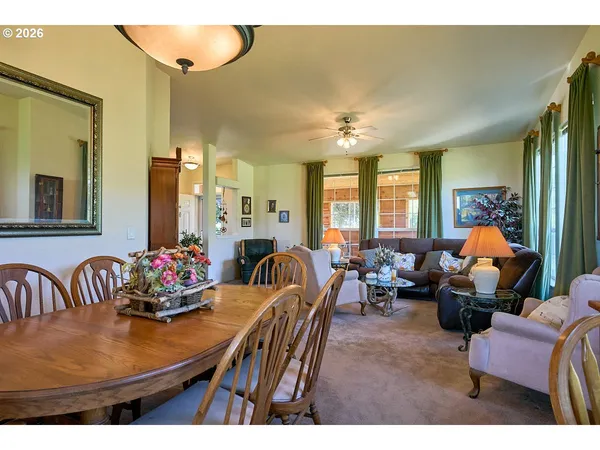 a view of a dining room with furniture and chandelier