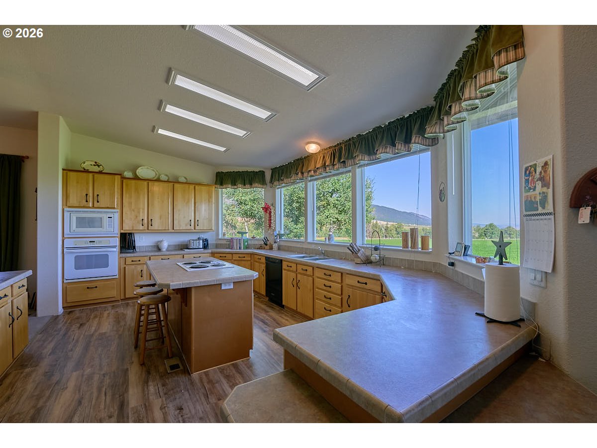 67079 Lostine River Road Lostine, OR 97857 - Photo 7 of 41 a kitchen with a table chairs and wooden floor