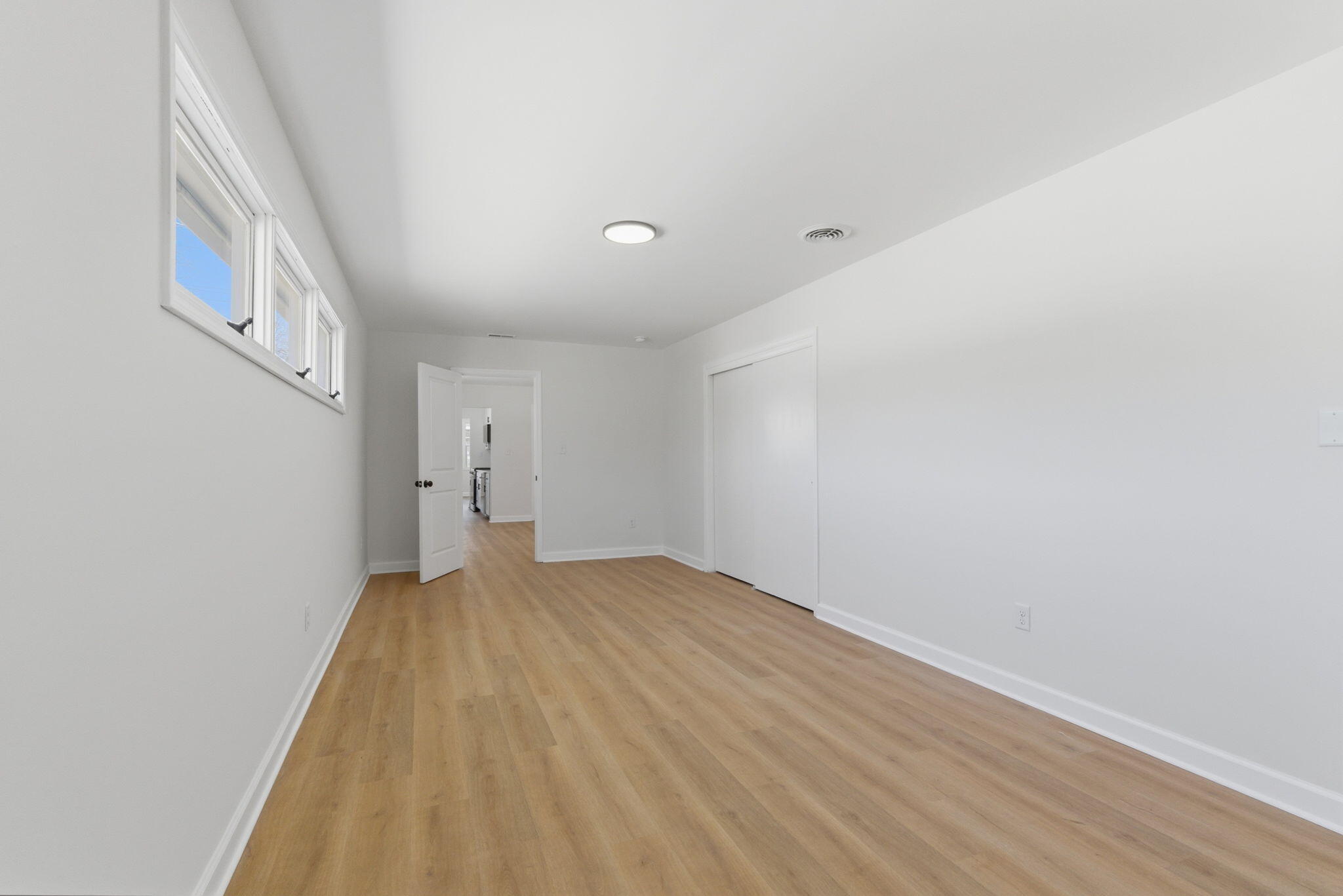 207 Harrington Avenue Crown Point, IN 46307 - Photo 12 of 21 a view of an empty room with wooden floor and a window