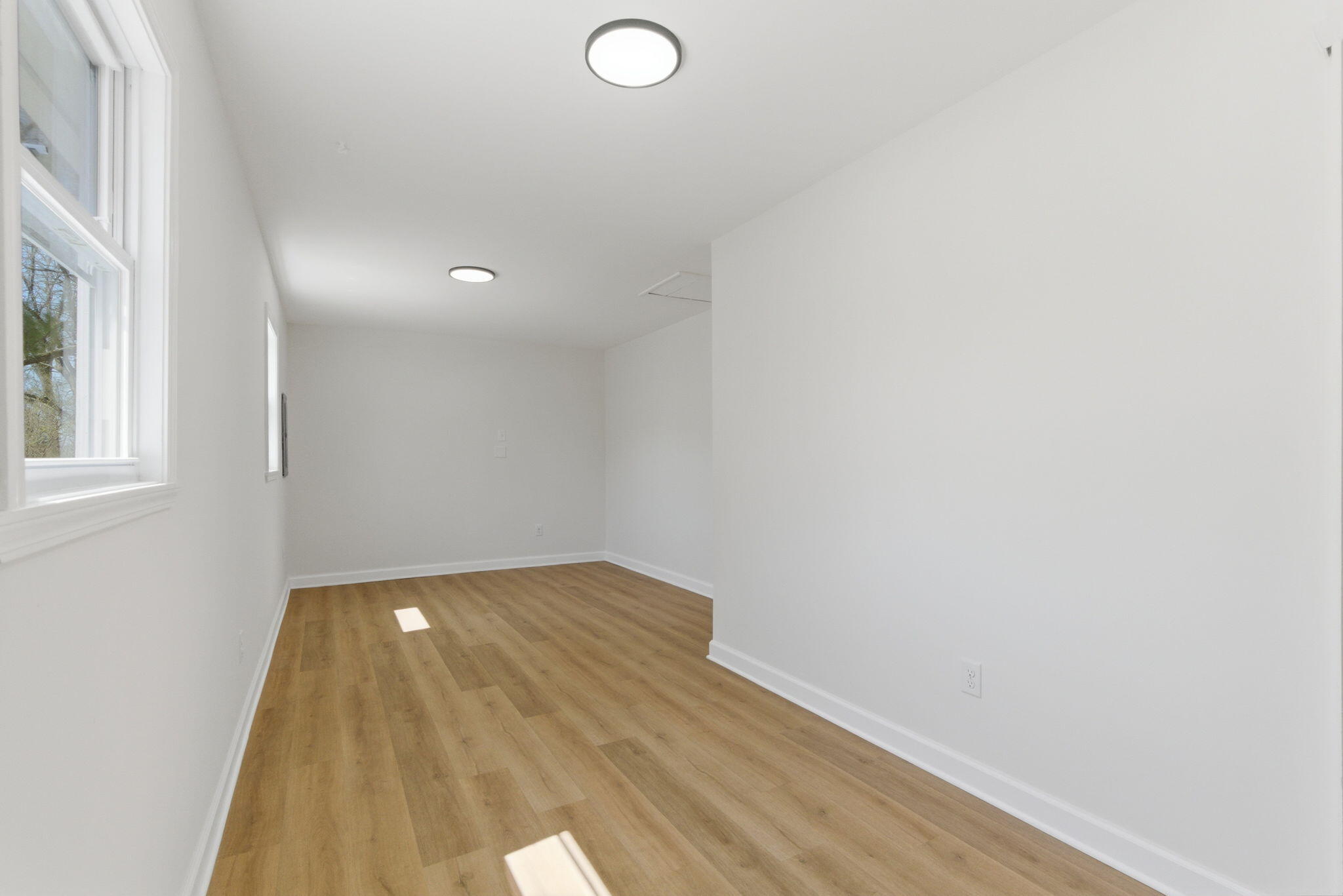 207 Harrington Avenue Crown Point, IN 46307 - Photo 14 of 21 an empty room with wooden floor and windows