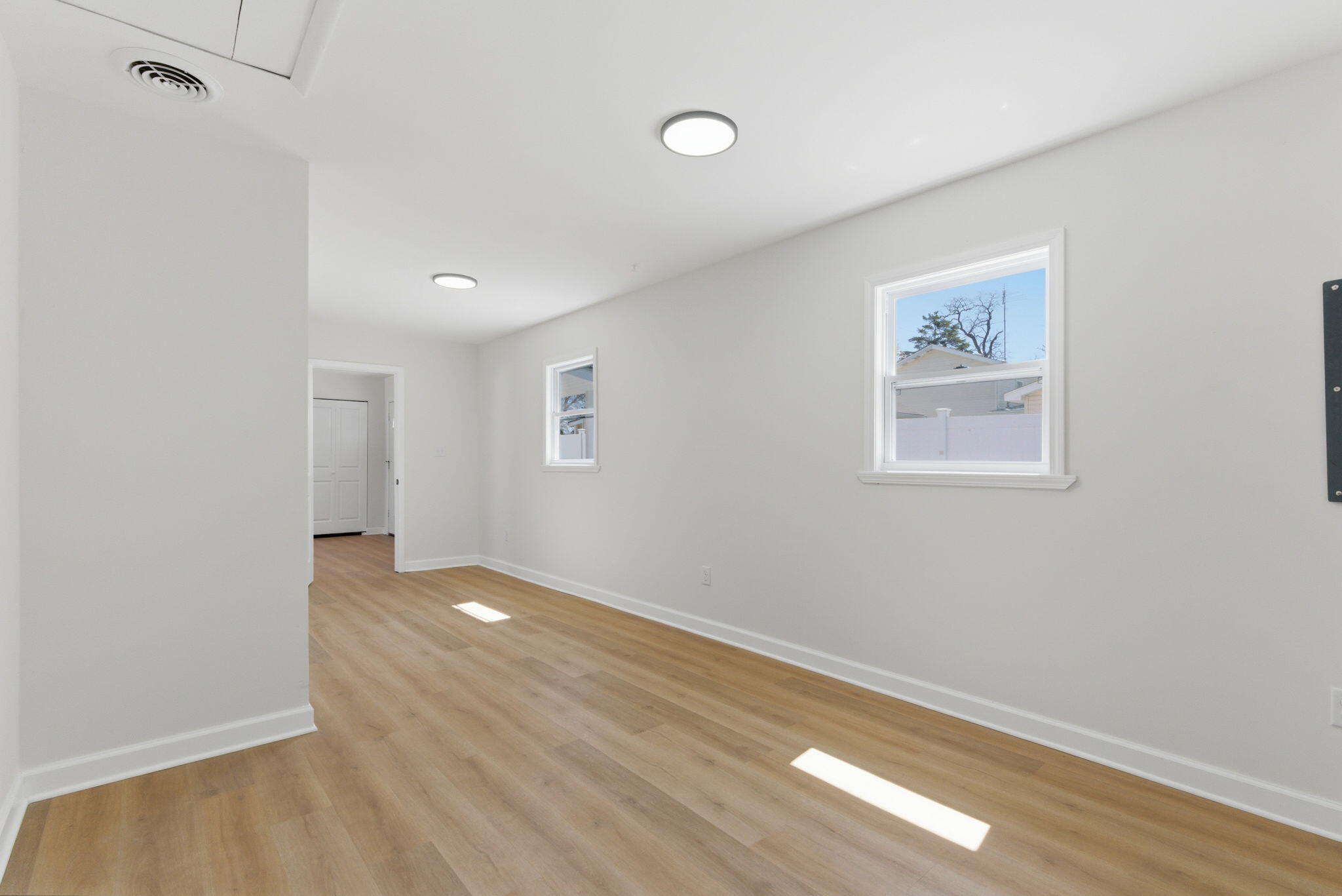 207 Harrington Avenue Crown Point, IN 46307 - Photo 15 of 21 an empty room with wooden floor and windows