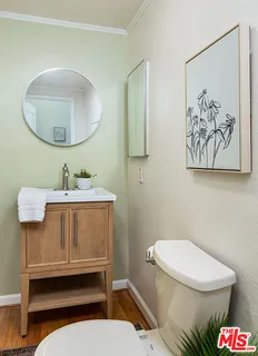 a bathroom with a toilet a sink and a mirror