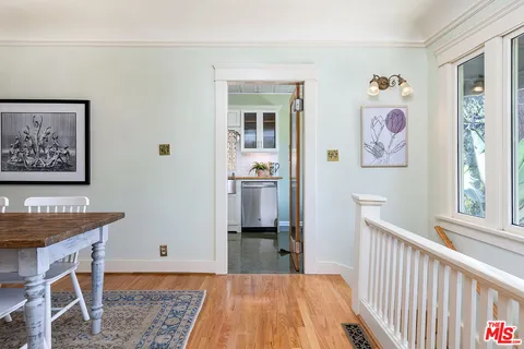a view of a bedroom with baby bed and workspace