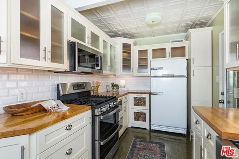 a kitchen with stainless steel appliances granite countertop a stove and a refrigerator