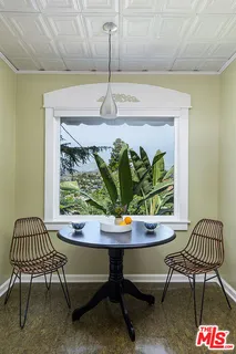 a outdoor sitting area with couch and a potted plant