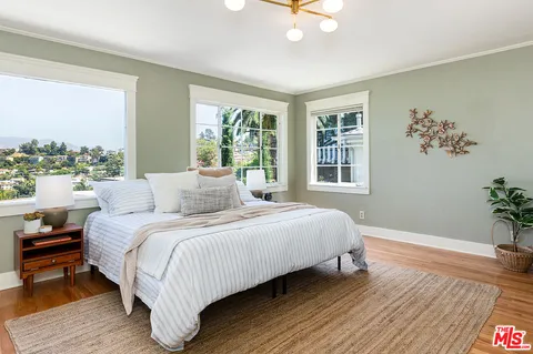 a bedroom with a large bed and a window