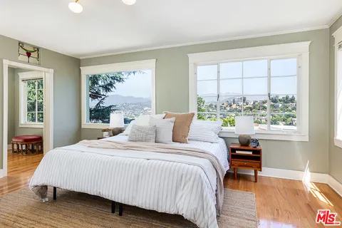 a bedroom with a bed and a window