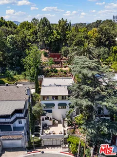 an aerial view of residential houses with outdoor space and street view