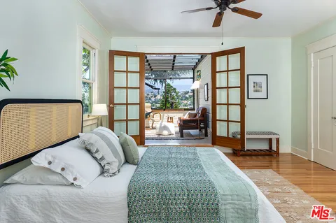 a bedroom with a large bed and a window