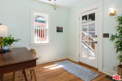 a view of room with window and wooden floor