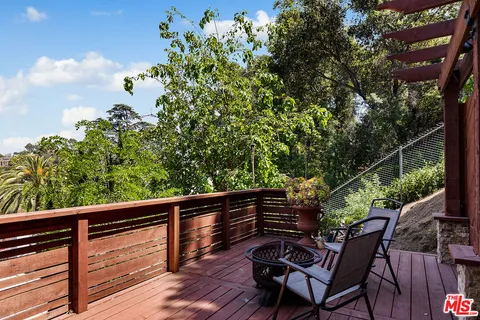 a view of balcony with wooden floor and outdoor seating