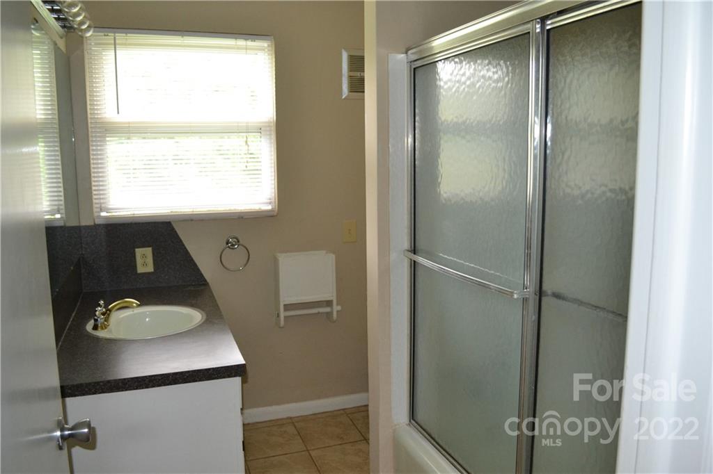 2751 Lail Road Morganton, NC 28655 - Photo 19 of 32 a bathroom with a sink vanity and a mirror