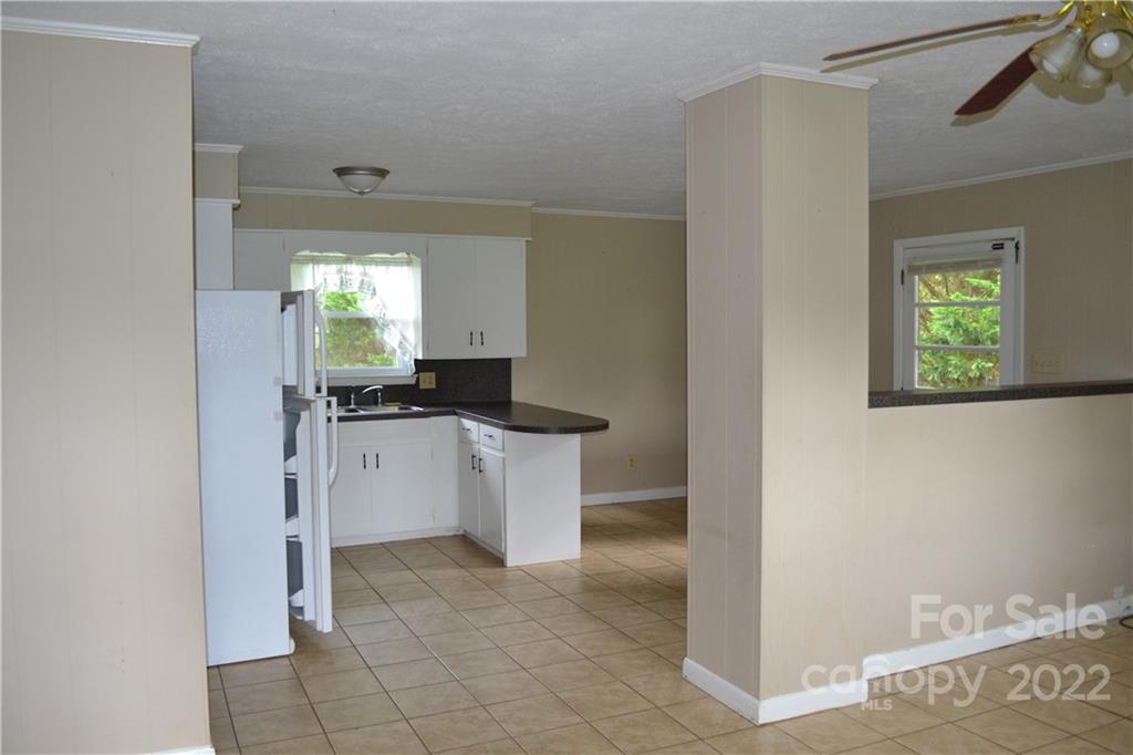 2751 Lail Road Morganton, NC 28655 - Photo 23 of 32 a kitchen with a refrigerator and white cabinets