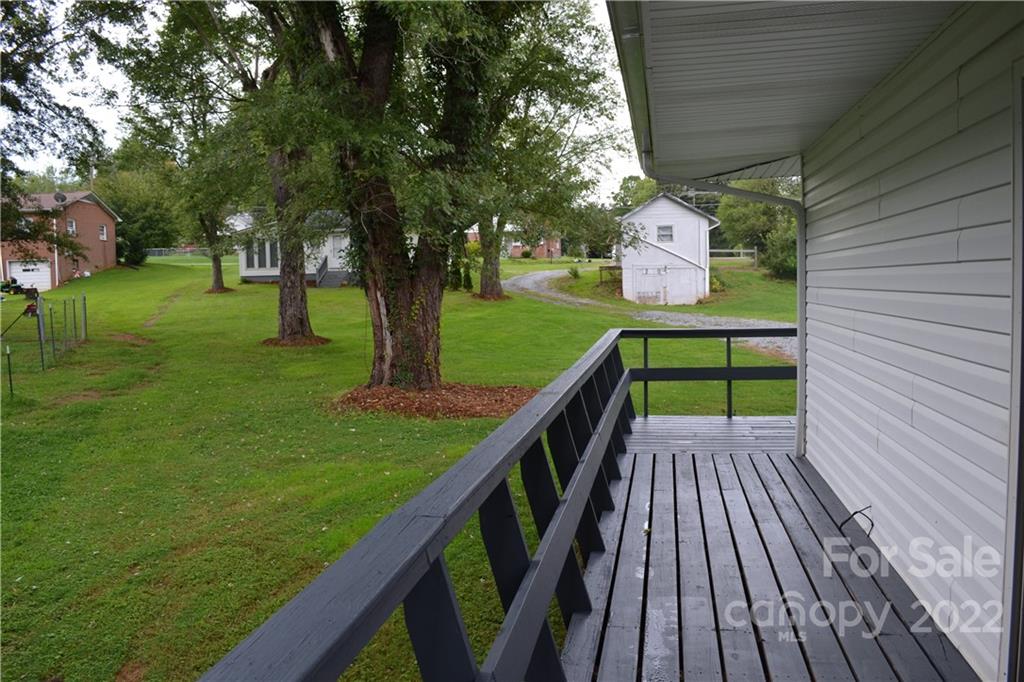 2751 Lail Road Morganton, NC 28655 - Photo 24 of 32 a balcony with wooden floor and trees in the back