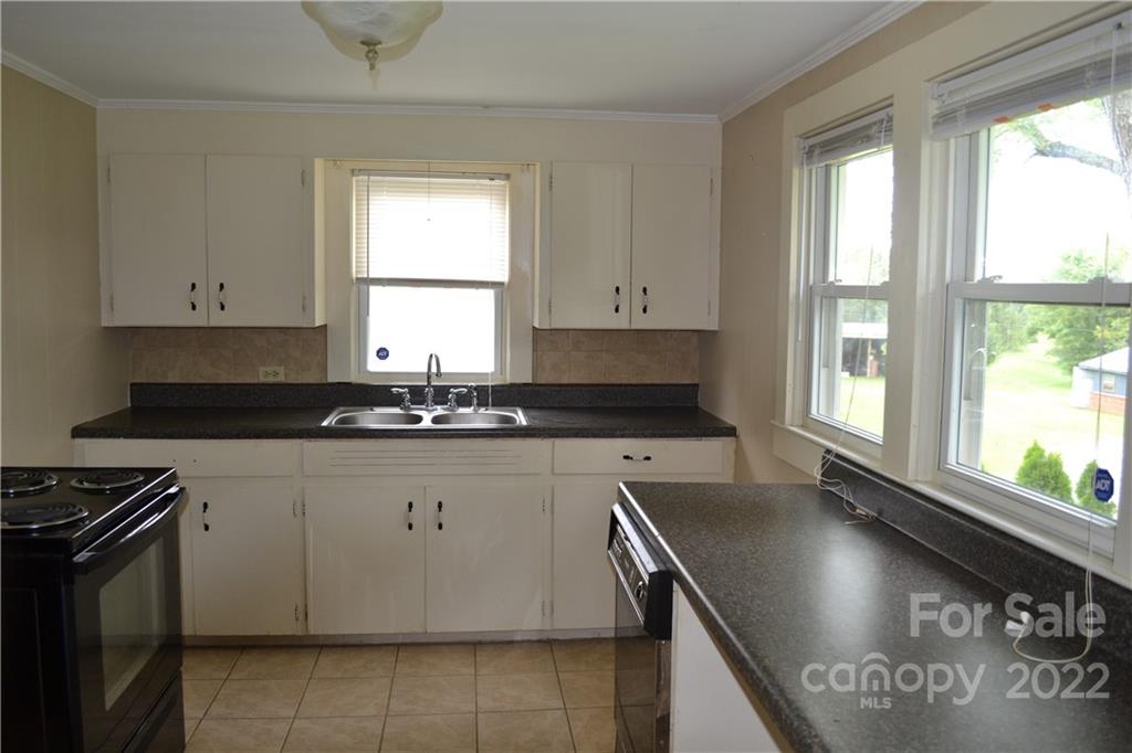 2751 Lail Road Morganton, NC 28655 - Photo 8 of 32 a kitchen with stainless steel appliances granite countertop a sink stove and cabinets