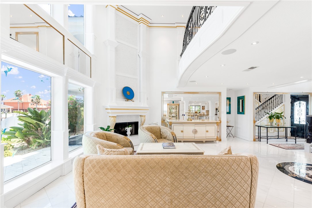 15910 El Soccorro Loop Corpus Christi, TX 78418 - Photo 12 of 40 a living room with furniture a fireplace and a large window with garden view