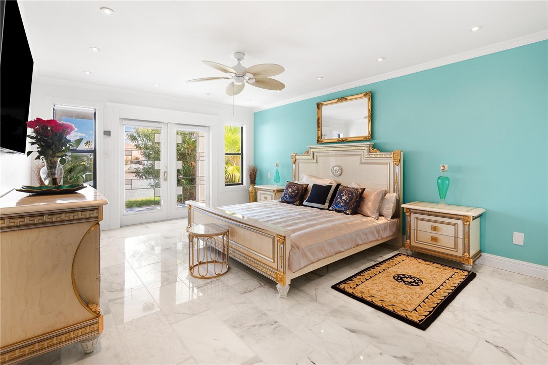 15910 El Soccorro Loop Corpus Christi, TX 78418 - Photo 20 of 40 a bedroom with a bed and a chandelier