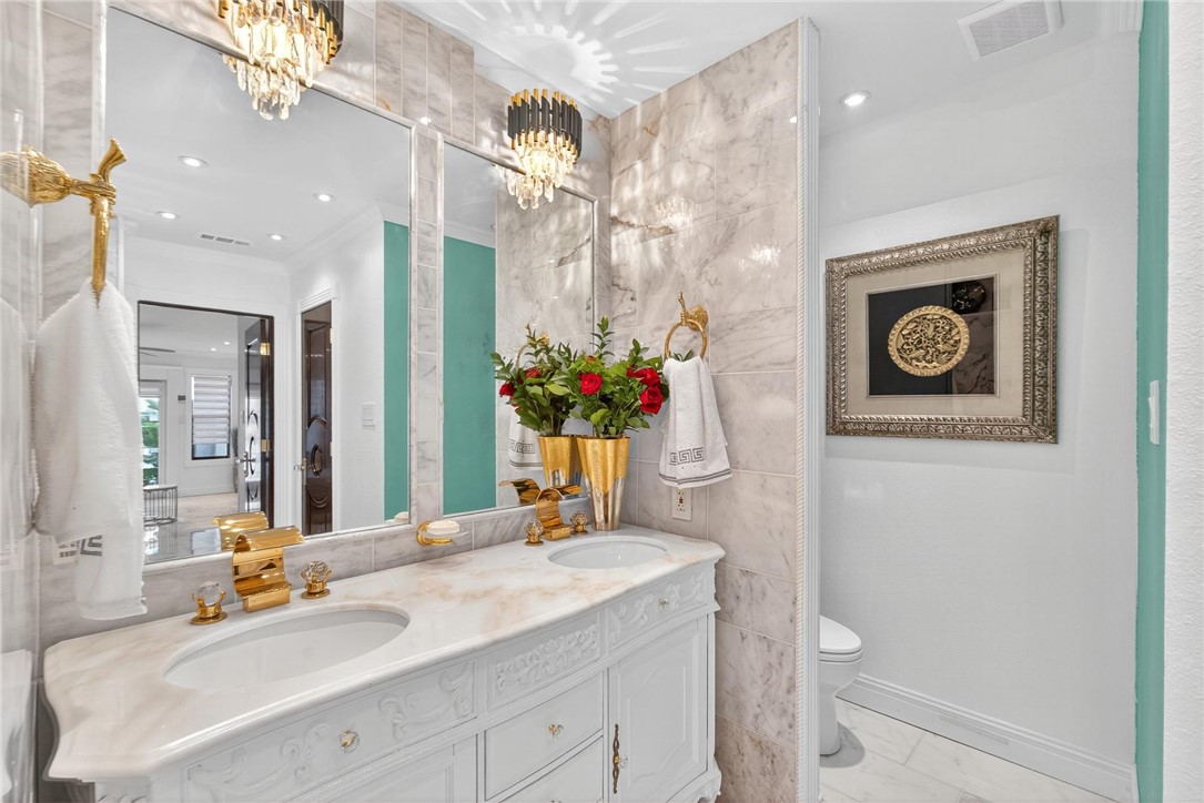 15910 El Soccorro Loop Corpus Christi, TX 78418 - Photo 22 of 40 a bathroom with a toilet sink and mirror