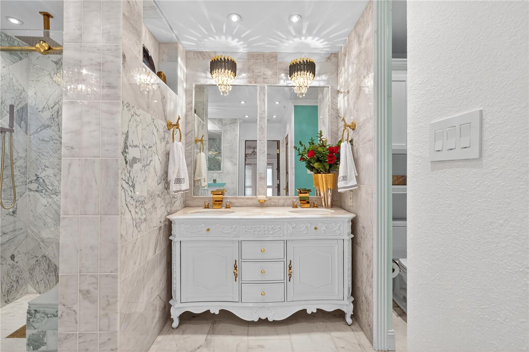 15910 El Soccorro Loop Corpus Christi, TX 78418 - Photo 23 of 40 a view of a bathroom with a sink and mirror