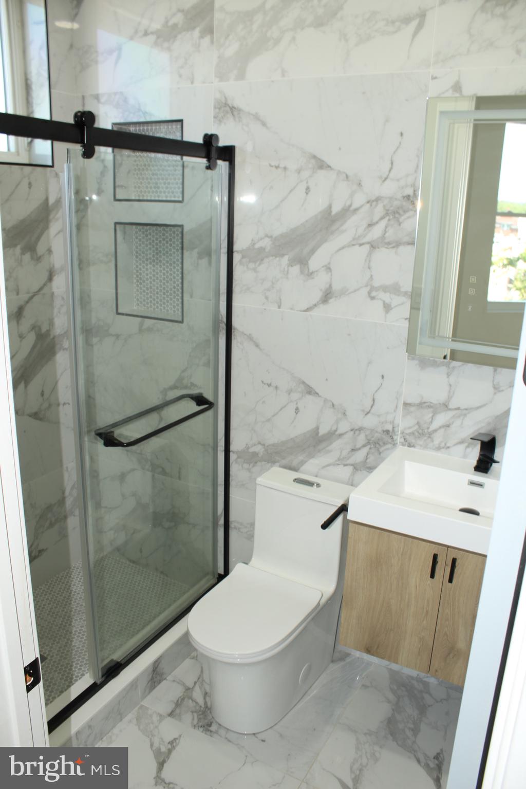 3017 Ridge Avenue, Unit B Philadelphia, PA 19121 - Photo 22 of 29 Sleek modern bathroom with marble elegance.