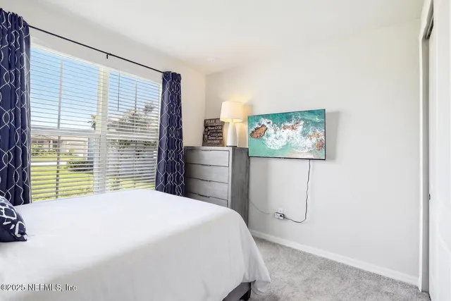 a view of a workspace with furniture and a bookshelf