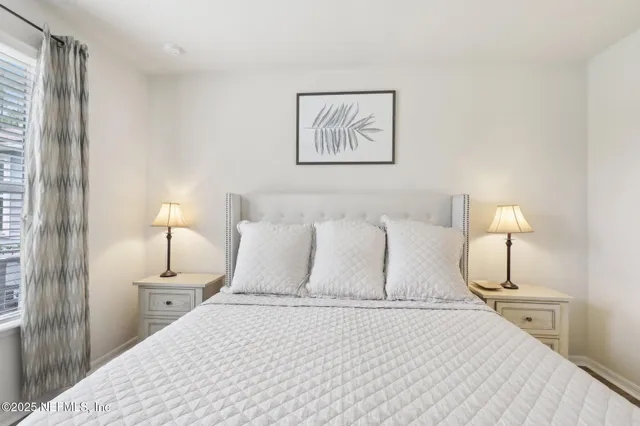 a bedroom with a bed and a mirror