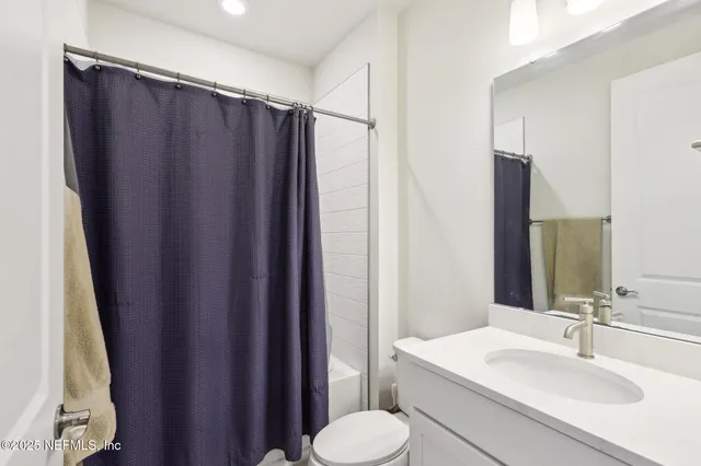 a bathroom with a double vanity sink a mirror and a shower