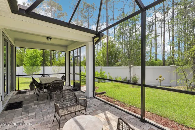 a view of a house with backyard porch and sitting area