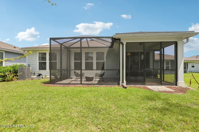 an aerial view of a residential house with outdoor space and parking