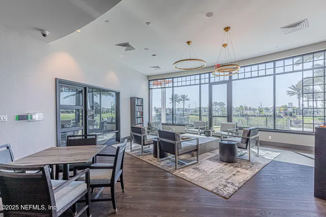 a living room with lots of furniture and a large window